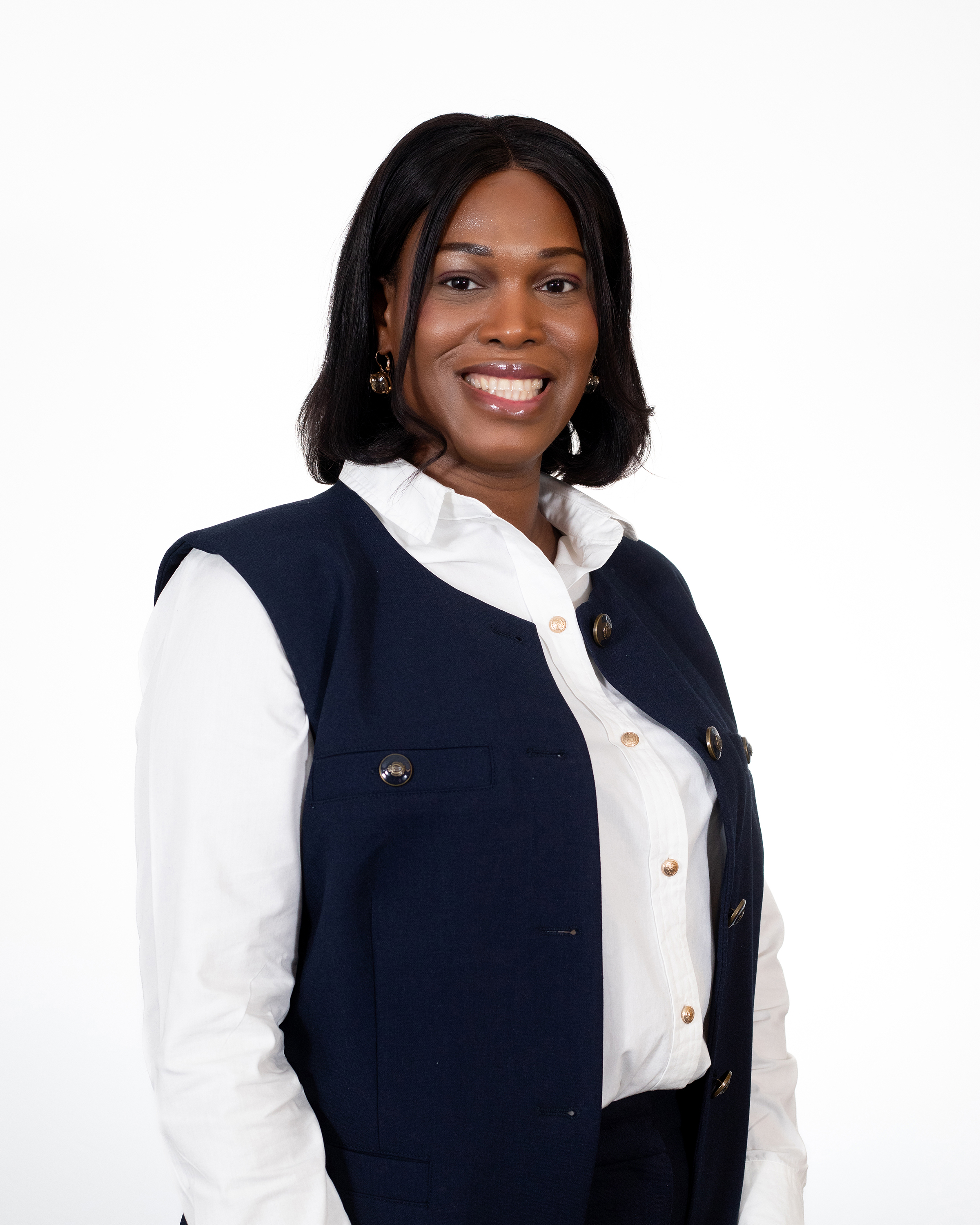 Pastor Christin Joseph smiling in a navy vest and white blouse